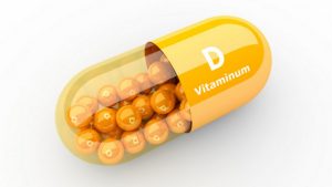 Vitamin D supplement pill on white background.